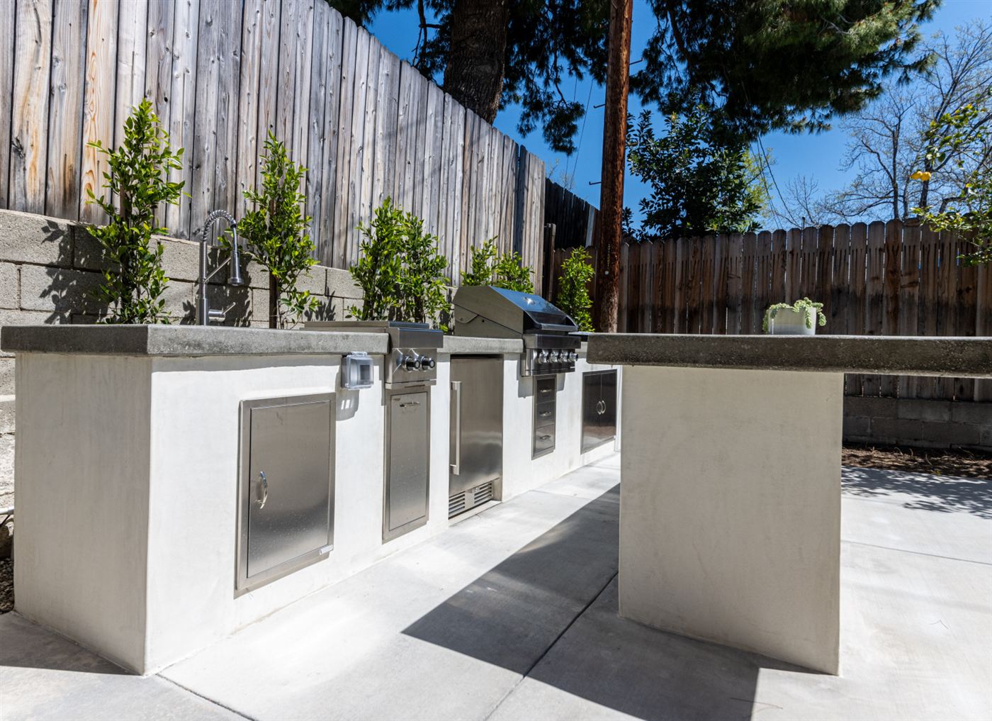 Outdoor kitchen with built-in stainless appliances