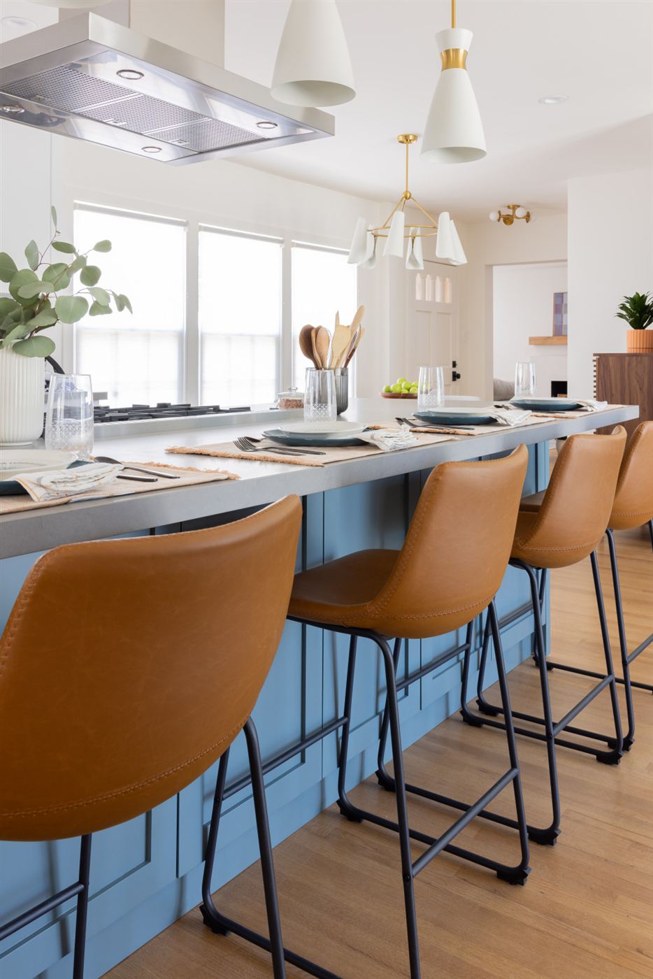 Bright and airy kitchen with gray quartz island and soft blue cabinetry