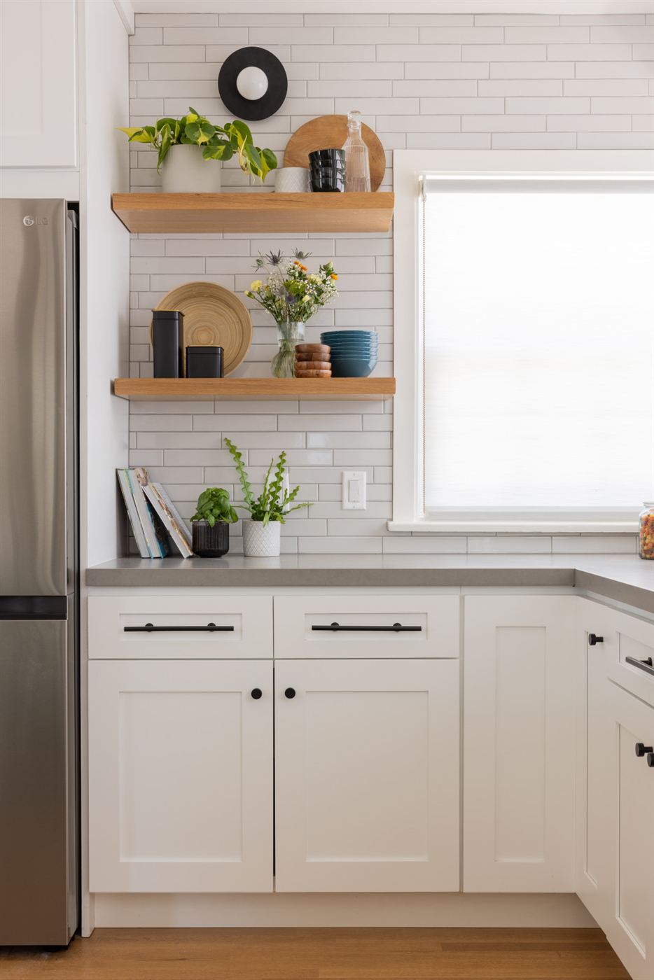 White and blue kitchen cabinets with subway tile backsplash