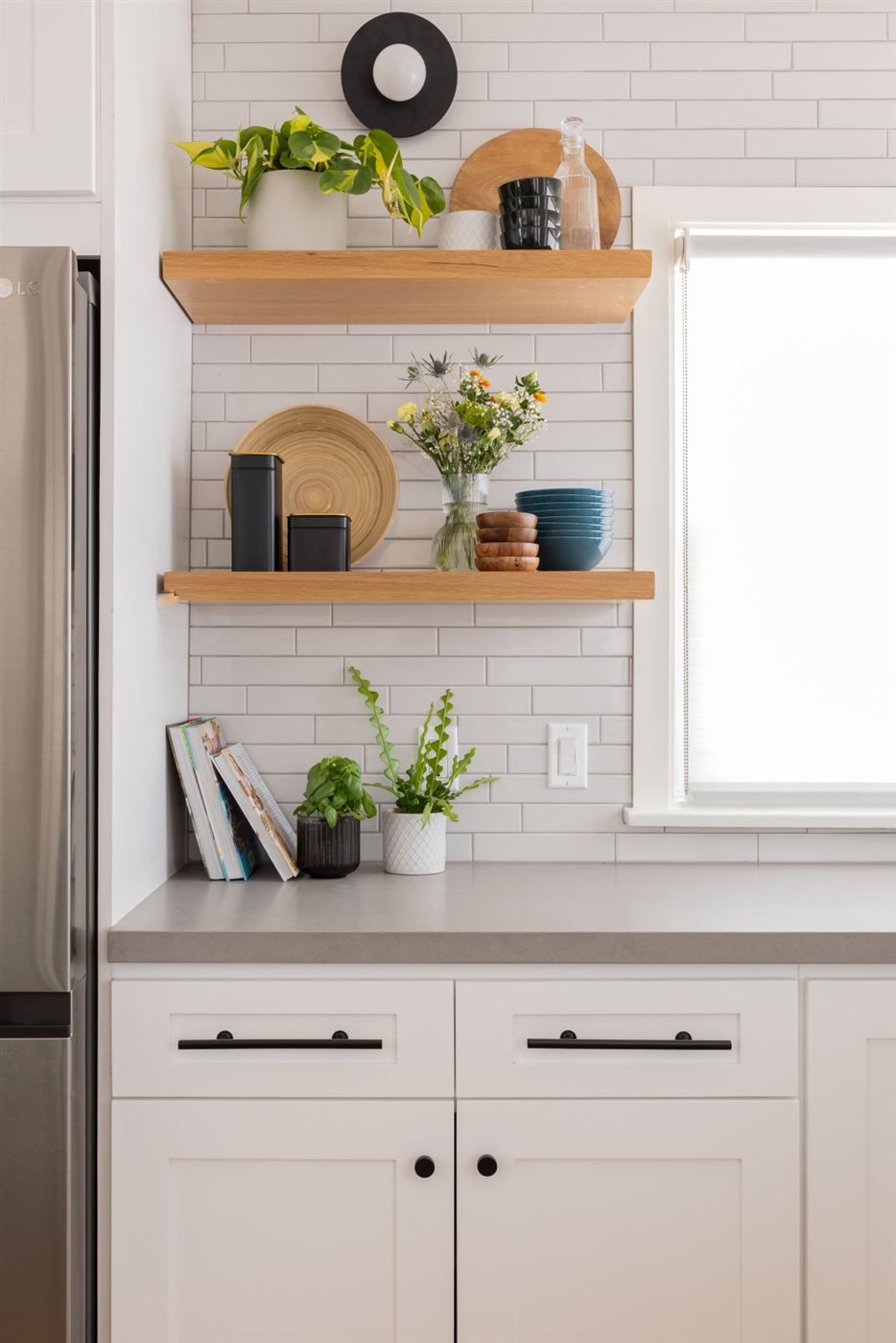 Kitchen with white subway tile and mixed cabinet colors