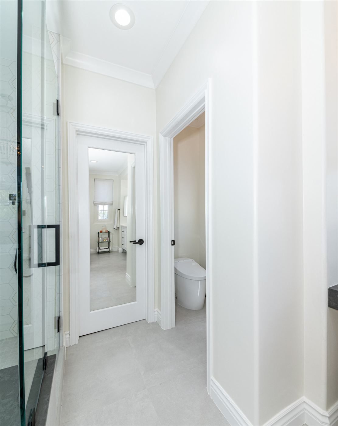 Bathroom hallway with glass shower enclosure