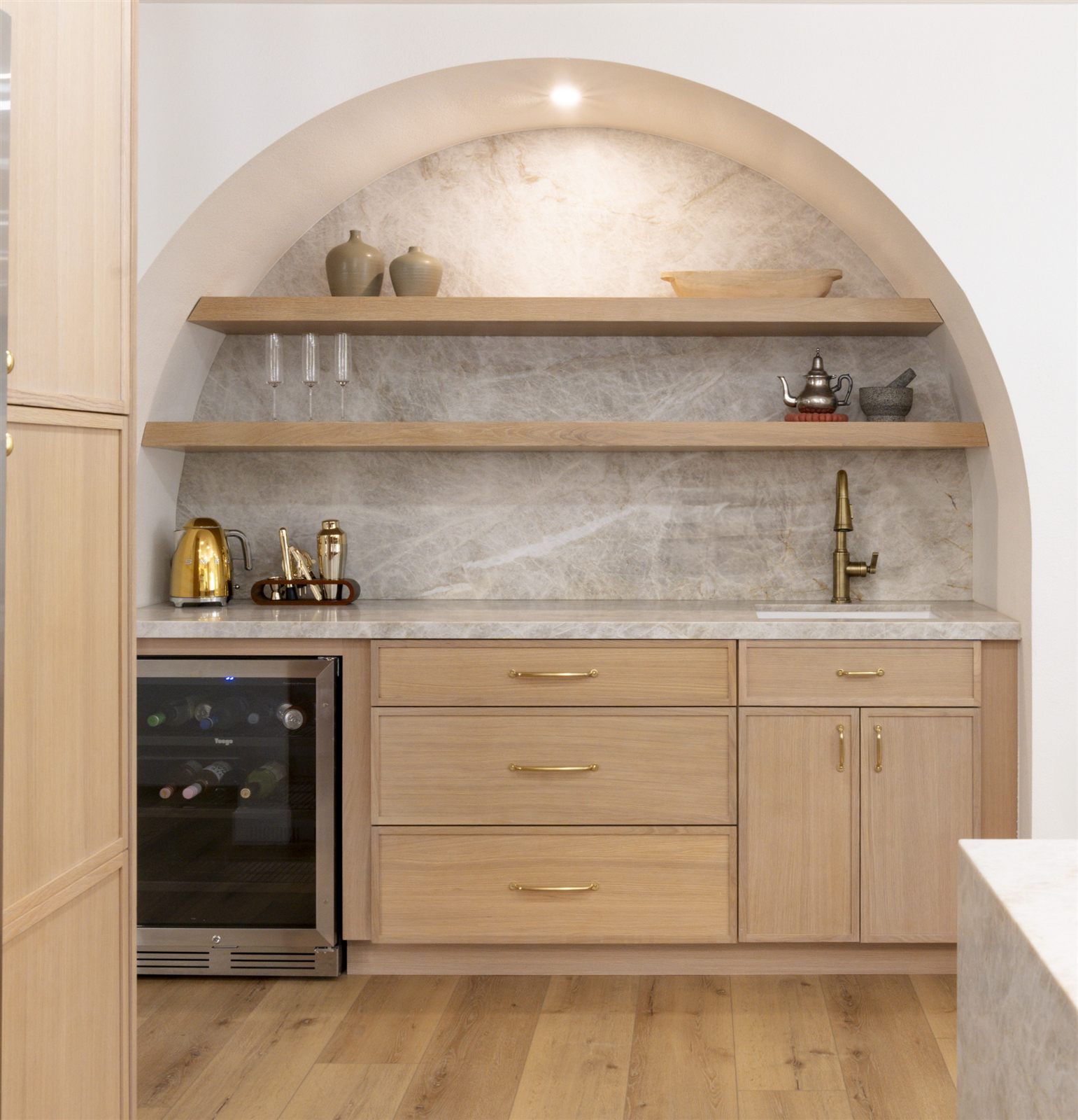 Custom arched wet bar with white oak cabinetry, part of an ADU build